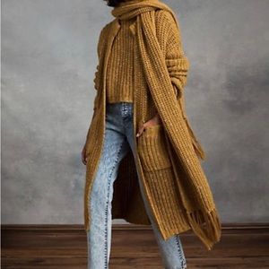 This is a long sweater coat in color, tan, brown and beige.